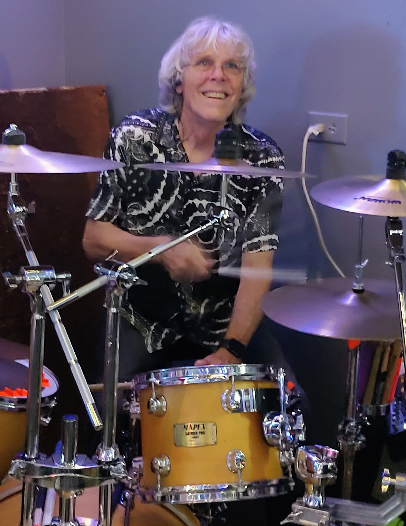 Rick Mason smiling behind his drum kit